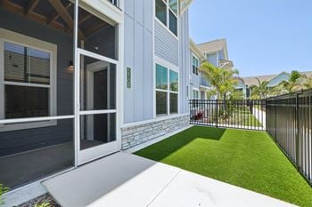 A modern house with a white door and a black fence.